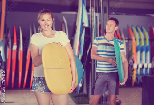 Couple is ready for surfing with board in time summer holidays