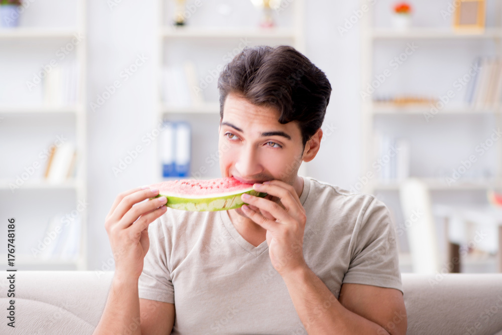 Man eating watermelon at home Man eating watermelon at home