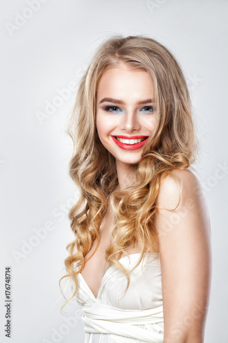 Perfect Fashion Model Woman with Blonde Permed Hair. Portrait of Cute Smiling Girl