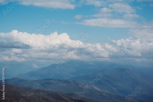 Panorama of mountain landscape, mountain range or peak in low clouds
