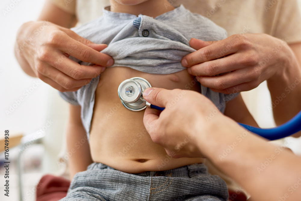Closeup of doctor listening to childs breathing putting stethoscope to bare  chest checking for symptoms of bronchitis Stock Photo | Adobe Stock