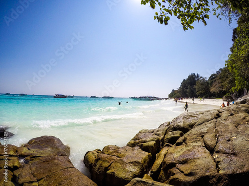 Happiness amidst the emerald sea, white sand and natural rocks. © Nattakarn