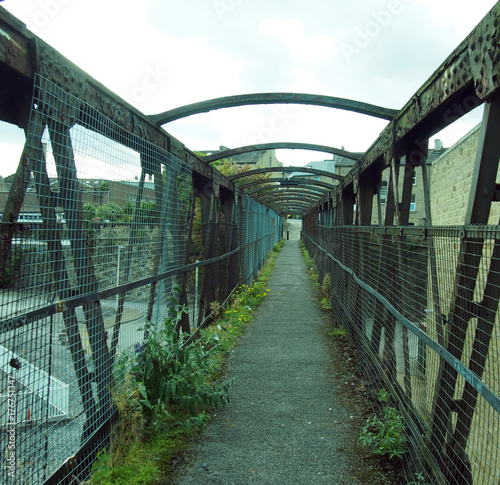 perspective view of an old rusting railway footbridge in halifax west yorkshire