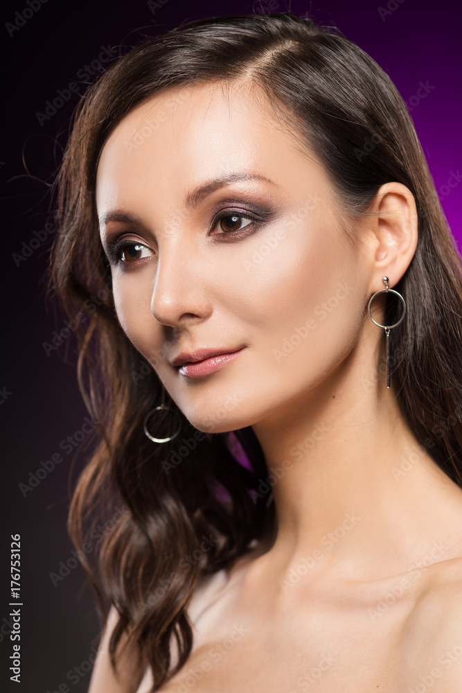 The beautiful girl portrait on a violet background The beautiful girl portrait on a violet background
