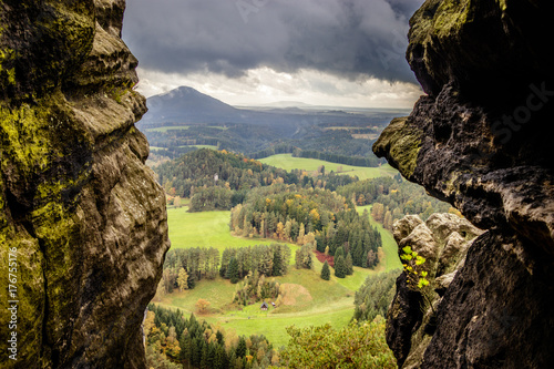 Sun breaking through after a storm on an autumn afternoon on a sandstone rock near Jetrichovice, beautiful landscape, mystic trails, Bohemian Switzerland, Czech Republic photo