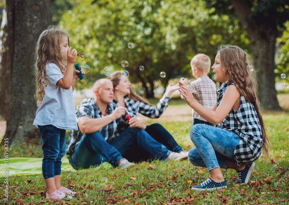Young family with cheerful children in the park
