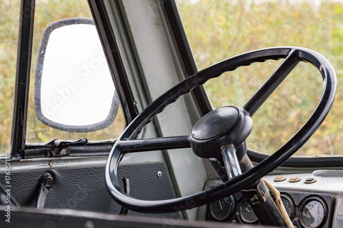 The steering wheel in the cockpit of an old car. Retro style