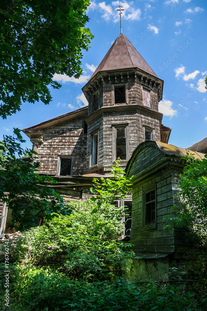 Abandoned, ruined and overgrown wooden church 