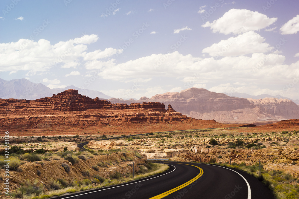 Desert Road Past Mesas and Buttes Through Glen Canyon National Park in Utah