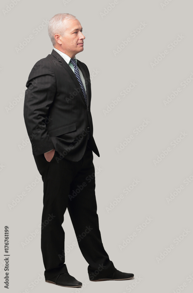 side view. senior businessman is putting his hands in his pockets. side view. senior businessman is putting his hands in his pockets.