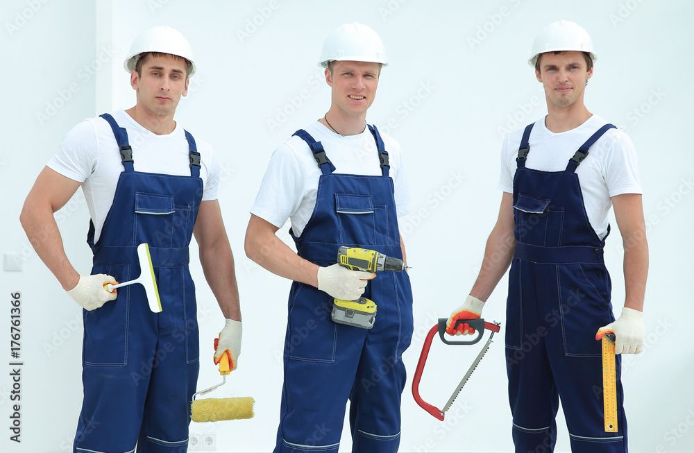 team of construction workers with working tools team of construction workers with working tools