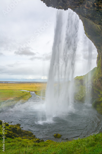 Amazing Seljalandsfoss waterfall from behind, Iceland