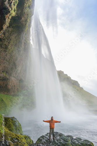 Traveler enjoying the amazing Seljalandsfoss waterfall in Iceland