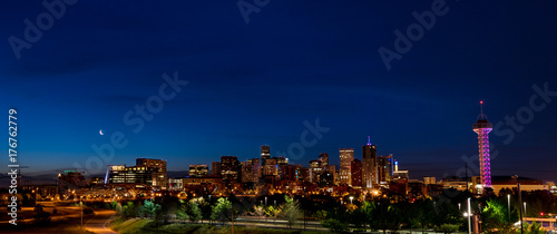 Full skyline of Denver Colorado at night with a moon © knowlesgallery