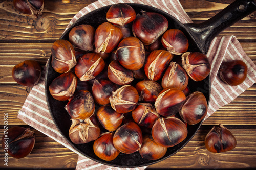 chestnuts in a pan on wooden background