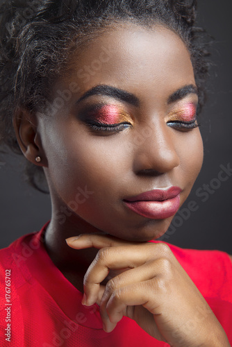 Glamorous makeup for the eyes closed to Africans close-up on black isolated background