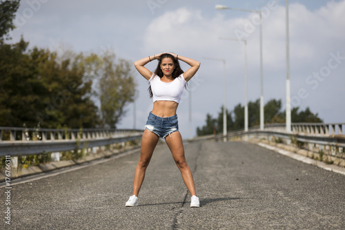 Fit girl wearing hot pants and white belly top © ginkgofoto