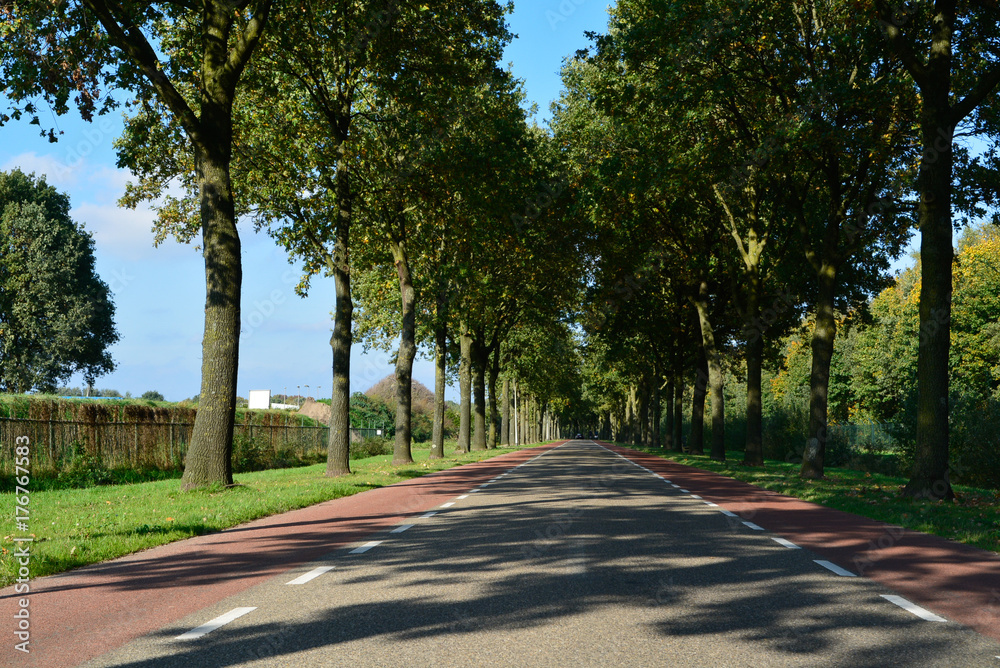 Dutch road between villages with bicycle paths, transportation in Europe