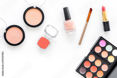 Eye shadows and rouges beige, nude colors on white background top view copyspace