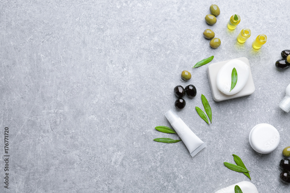 Cosmetics with olive oil extract on grunge table Cosmetics with olive oil extract on grunge table
