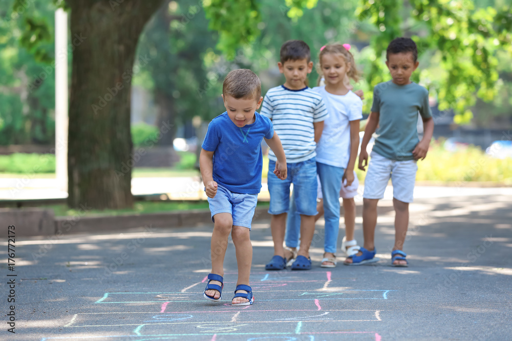 Obraz premium Little children playing hopscotch, outdoors