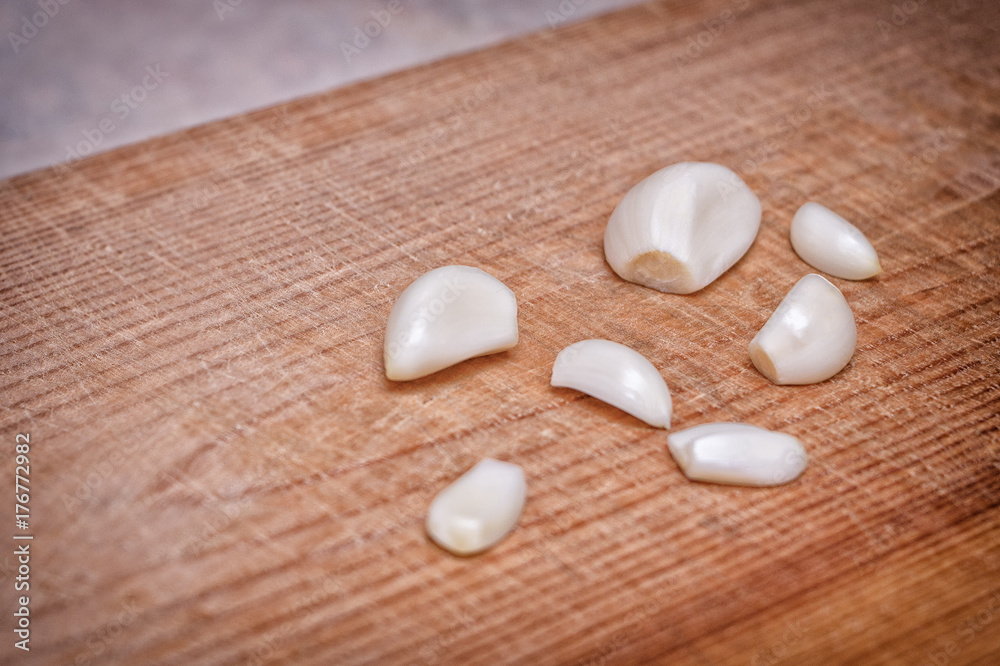 Garlic cloves closeup on wooden Board Garlic cloves closeup on wooden Board