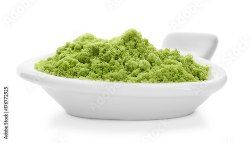 Bowl with wheat grass powder on white background © Africa Studio