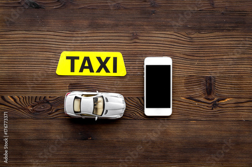online order a taxi set with car toy and mobile on wooden background top view mock up