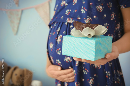 Pregnant woman holding gift...