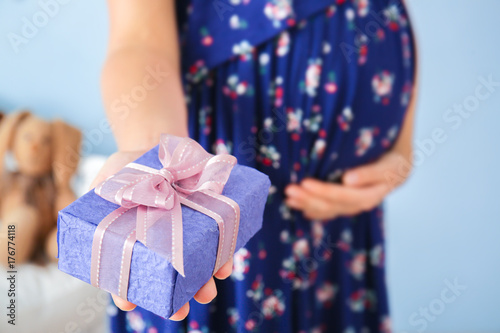 Pregnant woman holding gift...