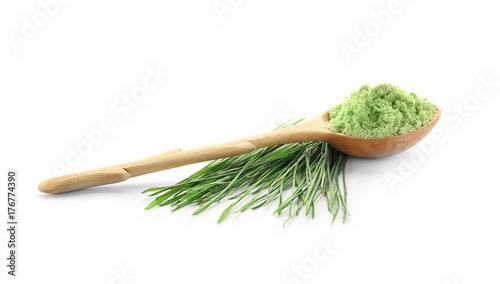 Spoon with wheat grass powder and sprouts, isolated on white
