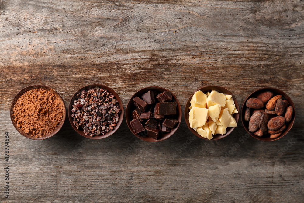 Bowls with cocoa products on wooden background Bowls with cocoa products on wooden background