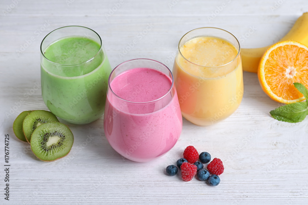 Glasses with different protein shakes on table Glasses with different protein shakes on table