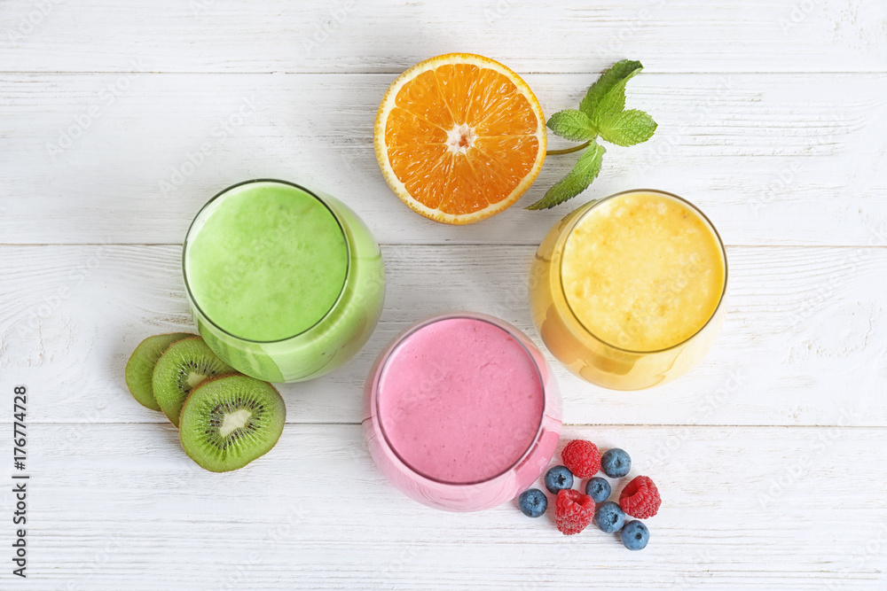 Glasses with different protein shakes on table Glasses with different protein shakes on table