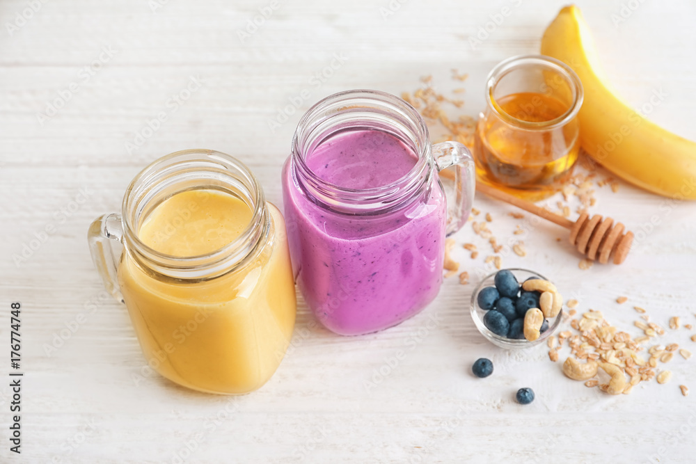 Jars with different protein shakes on table