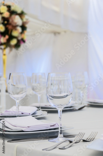 Beautifully decorated table for a celebration in a restaurant in white colors. © Alona Dudaieva