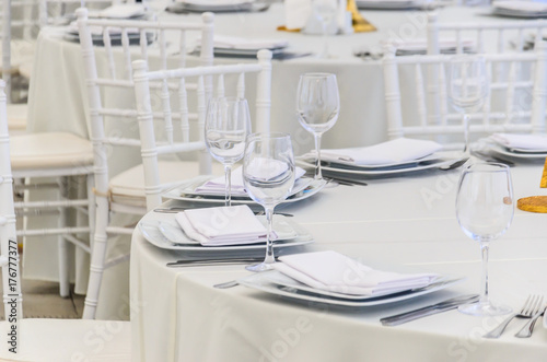 Beautifully decorated table for a celebration in a restaurant in white colors. © Alona Dudaieva