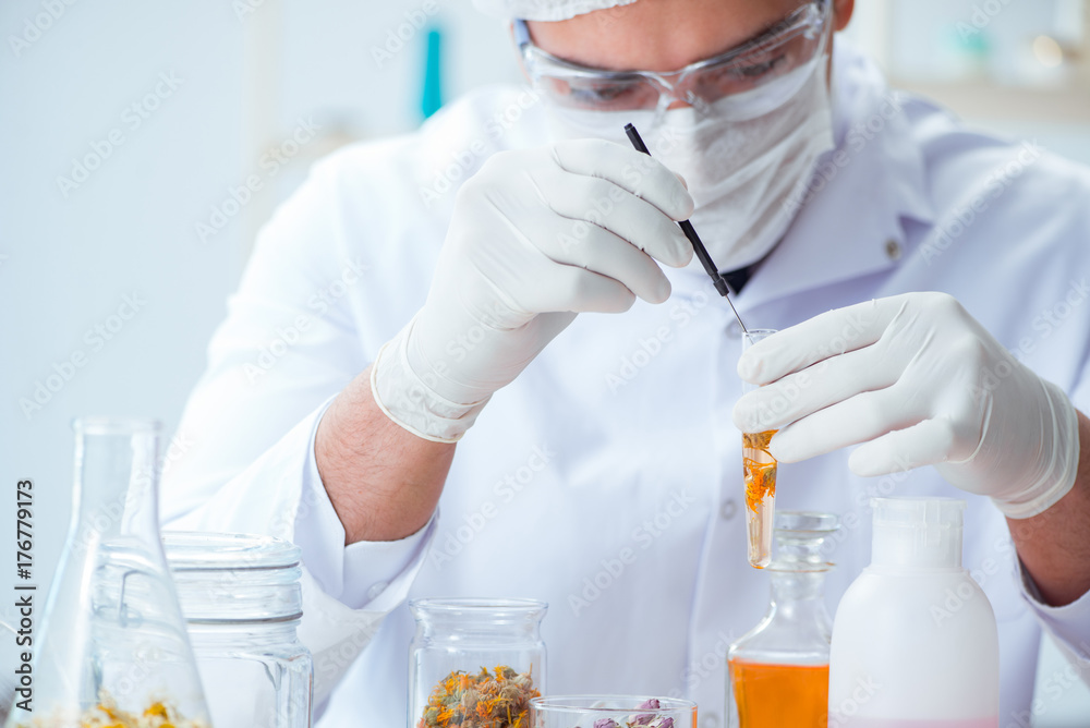 Chemist mixing perfumes in the lab Chemist mixing perfumes in the lab