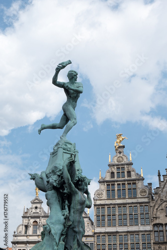 Brabo Fountain in the town square, Grote Markt, in the centre of Antwerp, Belgium with the Antwerp City Hall (Stadhuis van Antwerpen) behind.