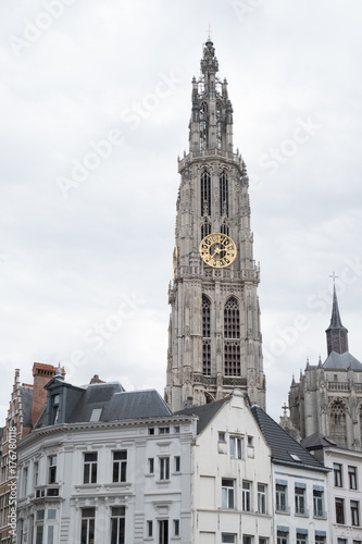 Cathedral of Our Lady (Onze-Lieve-Vrouwekathedraal), Antwerp, Belgium on an overcast day. Cathedral of Our Lady Antwerp Gothic clock tower amongst houses in the city of Antwerp.