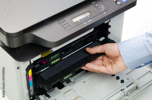 Man replacing toner in laser printer