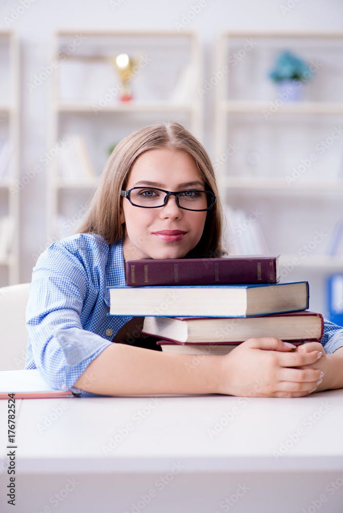 Young teenage female student preparing for exams at home
