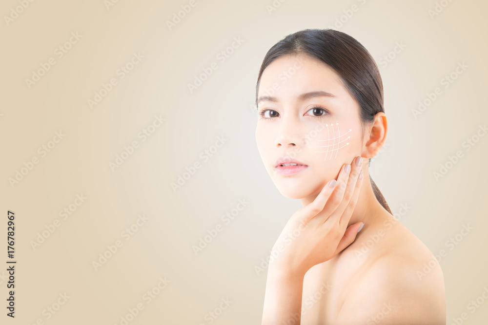 © N_studio - Portrait of beautiful asian woman makeup of cosmetic, girl hand touch cheek and smile with arrow antiaging, face of woman beauty perfect wellness on yellow background with skin healthcare concept. © N_studio - Portrait of beautiful asian woman makeup of cosmetic, girl hand touch cheek and smile with arrow antiaging, face of woman beauty perfect wellness on yellow background with skin healthcare concept.