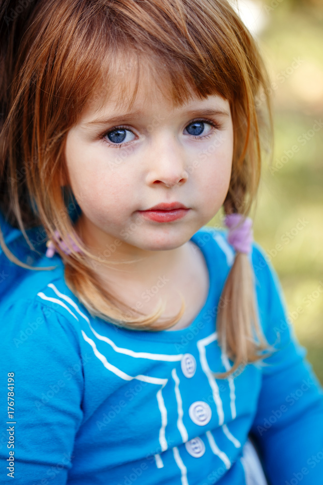 Closeup portrait of cute adorable little red-haired Caucasian girl child  with blue eyes looking in camera. Happy childhood concept Stock Photo |  Adobe Stock