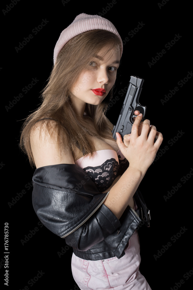 serious girl with gun on black background looking at camera serious girl with gun on black background looking at camera