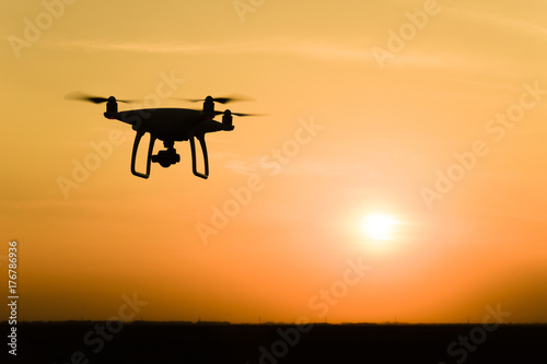 Quadrocopters silhouette against the background of the sunset © eleonimages