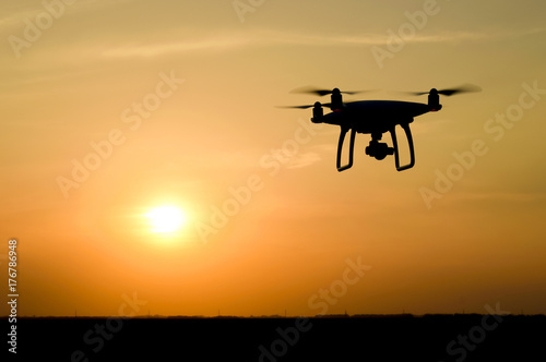 Quadrocopters silhouette against the background of the sunset © eleonimages