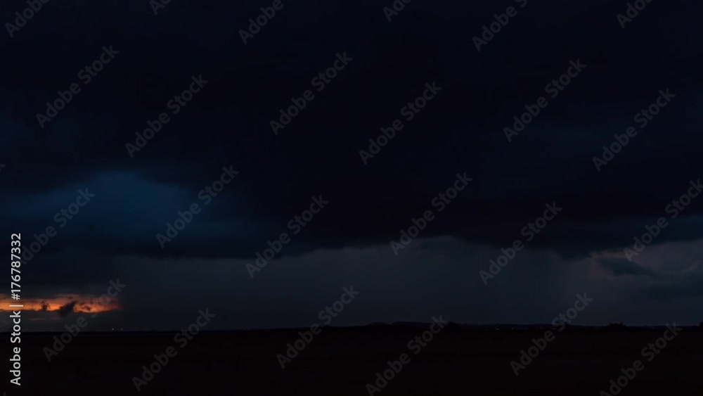 4K time lapse of storm cloud with rain over asphalt road and green grass field 4K time lapse of storm cloud with rain over asphalt road and green grass field