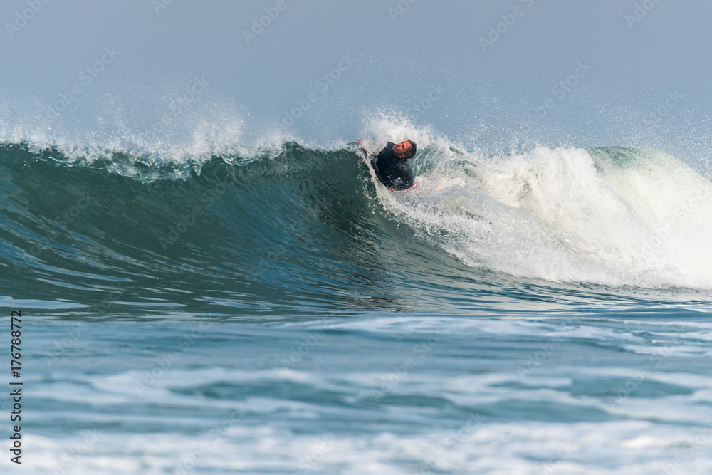 Bodyboarder surfing ocean wave Bodyboarder surfing ocean wave