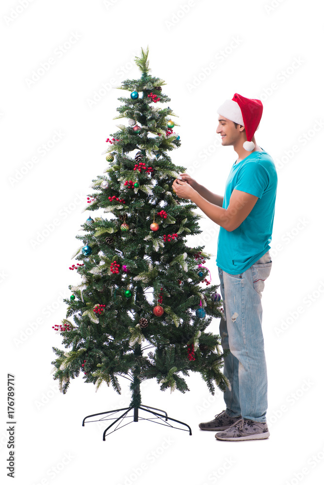 Young man decorating christmas tree isolated on white Young man decorating christmas tree isolated on white